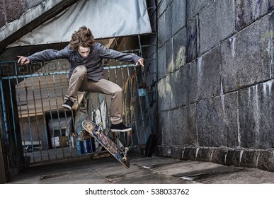 Jumping skateboarder on urban background