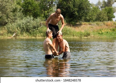 Jumping In The Water. Kids Have Fun And Splash In The Water. Summer Holiday Concept , Three Friends Are Having Fun On The River