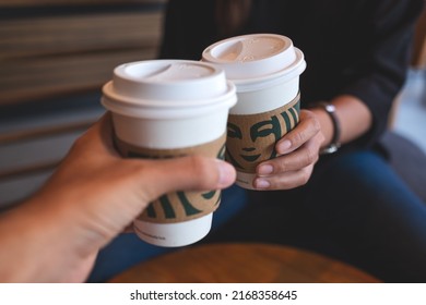 Jun 13th 2022 : Closeup Of A Couple People Holding And Clinking Two Cup Of Hot Coffee At Starbucks Coffee Shop, Chiang Mai Thailand 