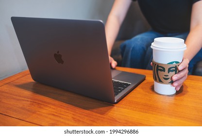 Jun 16th 2021 : A Woman Drinking Starbucks Coffee While Working On Apple MacBook Pro Laptop, Chiang Mai Thailand