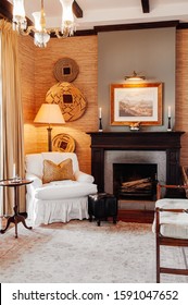 JUN 19, 2011 Serengeti, Tanzania - Luxury African Safari Lodge Living Room  Interior With Vintage White Armchair Under Warm Light And Antique Furniture Decoration