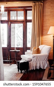 JUN 19, 2011 Serengeti, Tanzania - Luxury African Safari Lodge Living Room  Interior With Vintage White Armchair Under Warm Light And Antique Furniture Decoration