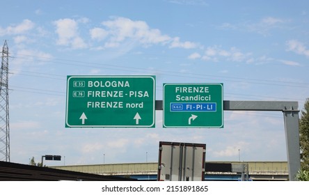 Junction with motorway sign with directions to the Italian cities Bologna Scandicci Pisa and the ring road called FI-PI-Li which are the initials of the places FIRENZE PISA LIVORNO