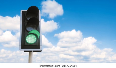 Junction traffic light with green color and blue sky background, that mean you can go - Shutterstock ID 2117754614