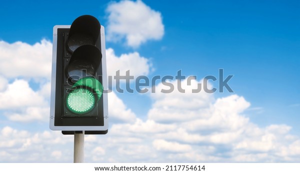 Junction traffic light with green color and\
blue sky background, that mean you can\
go