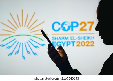 June 15, 2022, Brazil. In This Photo Illustration, A Woman's Silhouette Holds A Smartphone With The 2022 United Nations Climate Change Conference COP27 Logo In The Background