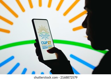 June 19, 2022, Brazil. In This Photo Illustration, A Woman's Silhouette Holds A Smartphone With The 2022 United Nations Climate Change Conference COP27 Logo Displayed On The Screen And In The Backgrou