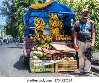 June 2, 2020 Ocoa, Dominican Republic. dramatic colourful image of a street vender selling fruit and mangos in a small caribbean village in the dominican republic mountains.