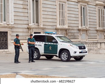 June 20, 2017. Civil Guardsmen Smile While On Duty With Rifles And Armor In Front Of The Royal Palace Of Madrid Next To A Van. Madrid, Spain.  