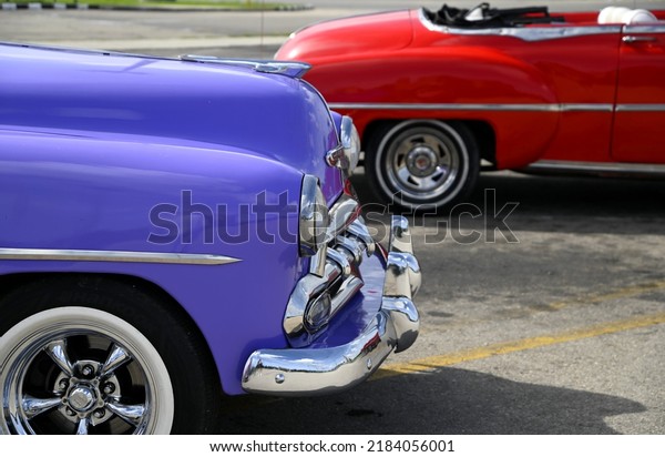 June 20, 2022. Vintage\
purple and red 1950 Chevrolet Bel Air antique cars with chrome\
bumpers, trim detail and white wall tires with chrome rims in\
Havana, Cuba. 