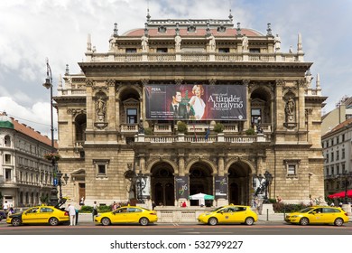 JUNE, 2016, BUDAPEST, HUNGARY - Budapest Opera House On Andrassy Avenue With Yellow Taxi Cars In Front