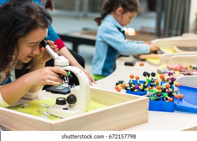 June, 2017. Minsk. Belarus. Museum Of Science In The National Library. A Woman And Children Look At The Molecules In A Microscope. STEM Education.