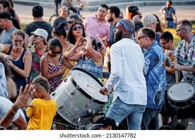 June, 2018 - Montreal, Canada: African American male playing beat drum in the crowd in Montreal, Canada.