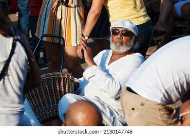 June, 2018 - Montreal, Canada: Elderly African American male playing djembe drum bongo in the crowd in Montreal, Canada.