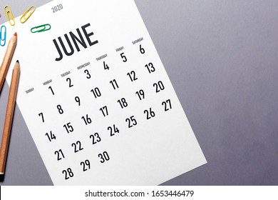 June 2020 simple calendar with office supplies and copy space