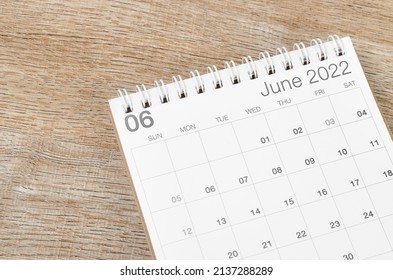 The June 2022 desk calendar on wooden background. - Shutterstock ID 2137288289