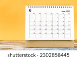 June 2023 Monthly desk calendar for 2023 year on yellow background.