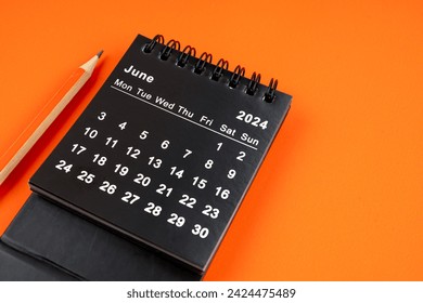 June 2024 desk calendar with pencil on orange color background. Arkivfotografi