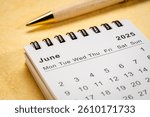 June 2025 - small spiral desktop calendar, time and business concept