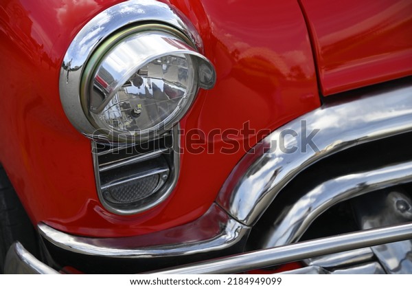 June 22, 2022. Vintage red 1956 Oldsmobile Futura with a\
polished chrome bumper, grill and chrome plated headlights in\
Havana, Cuba. 