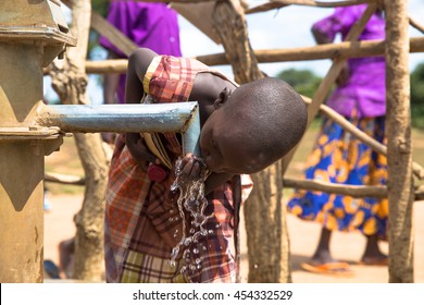 June 23, 2016: Soroti, Uganda. School children drink from a water well built by the organization Drop in the Bucket.