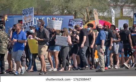 June 23, 2020 Phoenix, Arizona USA Anti Trump BLM protesters gather wearing masks during the pandemic in front of Dream City Church awaiting President Trump's arrival.