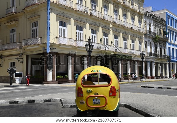 June 23, 2022.\
Cityscape with scenic view of a typical Coco-taxi the traditional\
rickshaw-type taxi vehicle on the streets of the historic center of\
Havana, Cuba. 