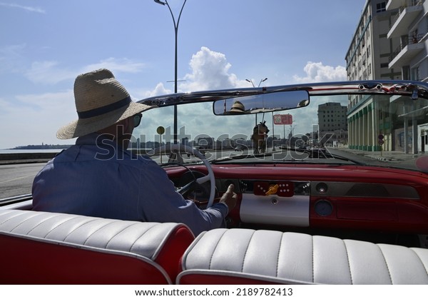 June 23, 2022. Sightseeing along the Malecón promenade\
on a vintage American convertible car with a local driver in\
Havana, Cuba. 