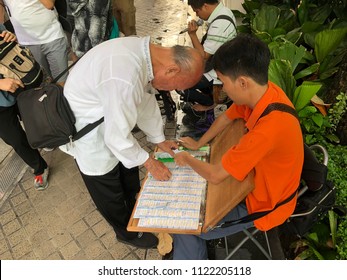 June 28, 2018 Bangkok. A Blind Vendor Sale Lottery Ticket To His Customer. Thai Lottery Is Draw Two Times A Month. Customers Are Hope To Be The Winner Of Multi-millions Baht In Cash.