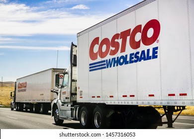 June 28, 2019 Stockton / CA / USA - Branded Costco Wholesale Trucks Driving On The Freeway 