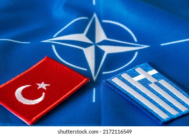June 29.30, Madrid, Spain. The flag of Turkey and Greece against the background of the NATO symbol, Concept, Discussing the situation between countries during the North Atlantic Summit.