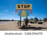 JUNE 30 2018 - PIE TOWN, NM: Traditional Native American thunderbird design on the stop sign near Pie Town New Mexico to lure tourists for a roadside attraction. Classic antique truck in background