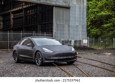 June 5, 2022 Portland Oregon USA - A Tesla Electric Car Parked Outdoors In The Rain In An Industrial Setting. 