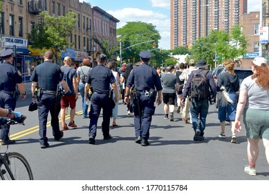 June 7, 2020 - Brooklyn, NY, US: A Wall Of Police Officers, Seen From Behind, Walks Behind Black Lives Matter Marchers At A Demonstration In Bay Ridge, Brooklyn.