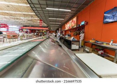 June 7, 2022 Santo Domingo,Dominican Republic. Dramatic Image Of Bravo Shopping Center With Workers Behind Deli And Shoppers Ordering Food.