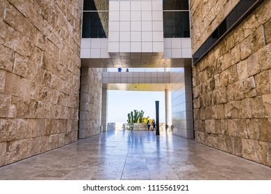 June 8, 2018 Los Angeles / CA / USA - Walking Corridor Between Travertine Covered Walls And Below An Aerial Walkway Connecting Buildings At The Getty Center;  