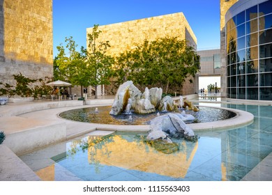 June 8, 2018 Los Angeles / CA / USA - Water Fountain In The Museum Courtyard Of The Getty Center At Sunset; Travertine Covered Wall, Illuminated By The Sun, Reflected In The Fountain's Pool