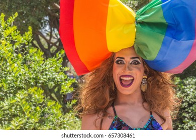 June 9, 2017. The Pride Parade In Tel-Aviv. Pride 2017. Portrait Of An Enthusiastic Girl With A Huge Multi-colored Bow On Her Head