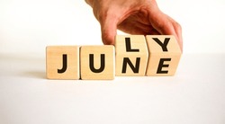 From June To July Symbol. Businessman Turns Wooden Cubes And Changes The Word 'june' To 'july'. Beautiful White Background, Copy Space. Business And From June To July Concept.