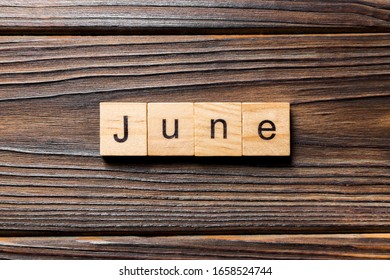 June word written on wood block. June text on wooden table for your desing, Top view concept.