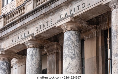 Juneau, Alaska, USA - July 19, 2011: Closeup, Frieze Of Alaska State Capitol, Stating As Much, On Top Of Marble Pillars. Brown Stone Building.