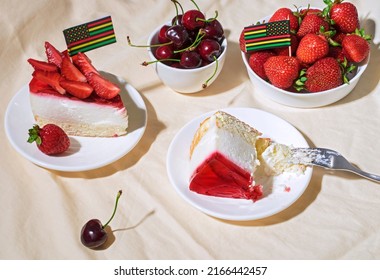 Juneteenth Day Picnic Background With Black Liberation African American Flags, Sweet Salad With Cherries And Strawberries, Strawberry Cheesecake