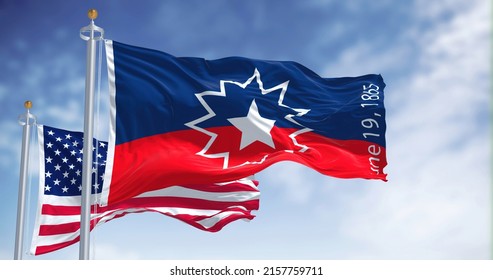 The Juneteenth flag waving in the wind with the american flag. Juneteenth is a federal holiday in the United States commemorating the emancipation of enslaved African-Americans - Shutterstock ID 2157759711