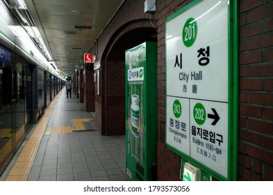 Jung, Seoul / South Korea - May 1 2018: Green sign on the wall of the platform of City Hall Station on the Seoul Subway Line 2.