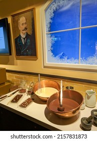 Jungfrau, Switzerland - August 19, 2019: Lindt Chocolate Shop In Jungfraujoch Station. On The Table Are The Ingredients For Making Swiss Chocolate. Vertical.