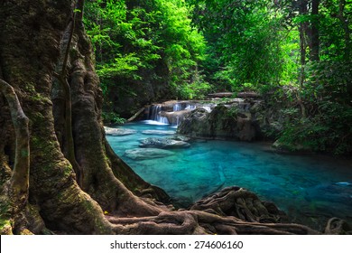 Jungle Landscape With Flowing Turquoise Water Of Erawan Cascade Waterfall At Deep Tropical Rain Forest. National Park Kanchanaburi, Thailand