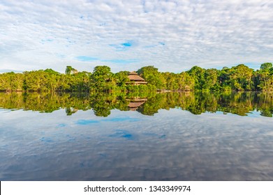 Jungle Lodge Located In The Amazon Rainforest By A Lagoon. The Tributaries Of The Amazon River Traverse The Countries Of Guyana, Ecuador, Peru, Brazil, Colombia, Venezuela, Suriname And Bolivia.