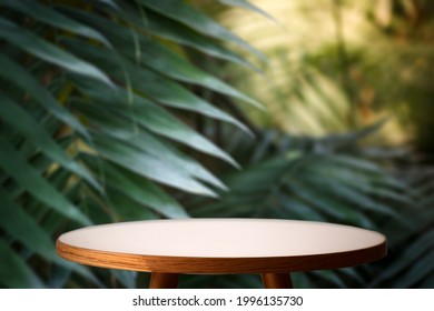 Jungle table background. Interior table for a cosmetic item against the backdrop of tropical plants, palms and jungle.