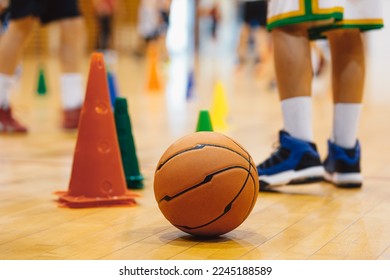 Junior basketball training. Boys practicing basketball on training session. Basketball on wooden floor on court - Powered by Shutterstock