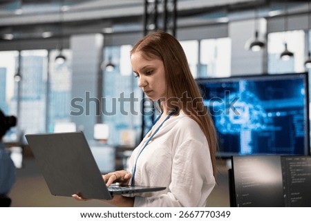 Junior dev in office using AI automation scripts to reduce repetitive coding tasks. Young female software developer using artificial intelligence technology in startup workspace